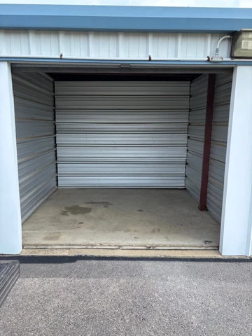 Empty drive-up storage unit with a swept concrete floor and open roll-up door in Staunton, VA